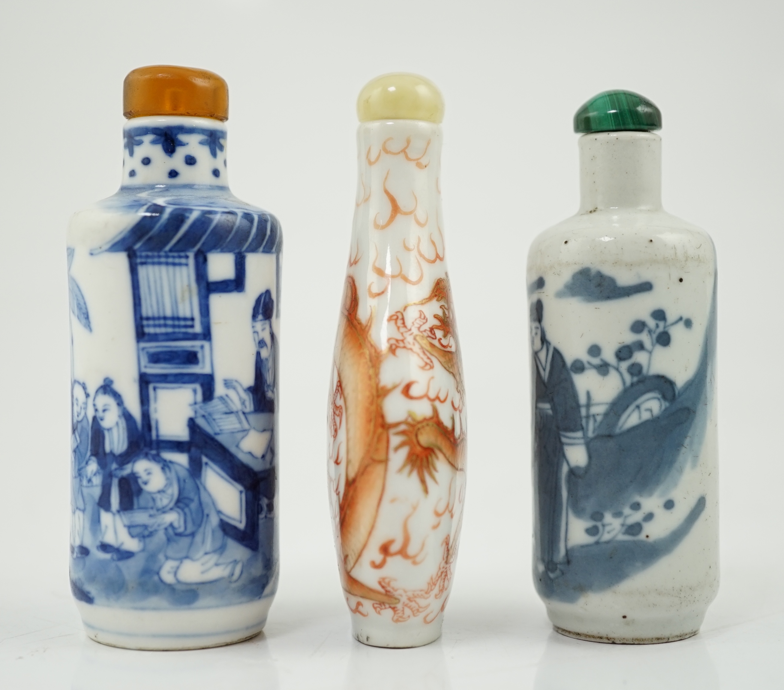 A Chinese iron red enamelled ‘dragon’ snuff bottle, Tongzhi mark and of the period (1862-74), together with two Chinese blue and white cylindrical snuff bottles, 19th century